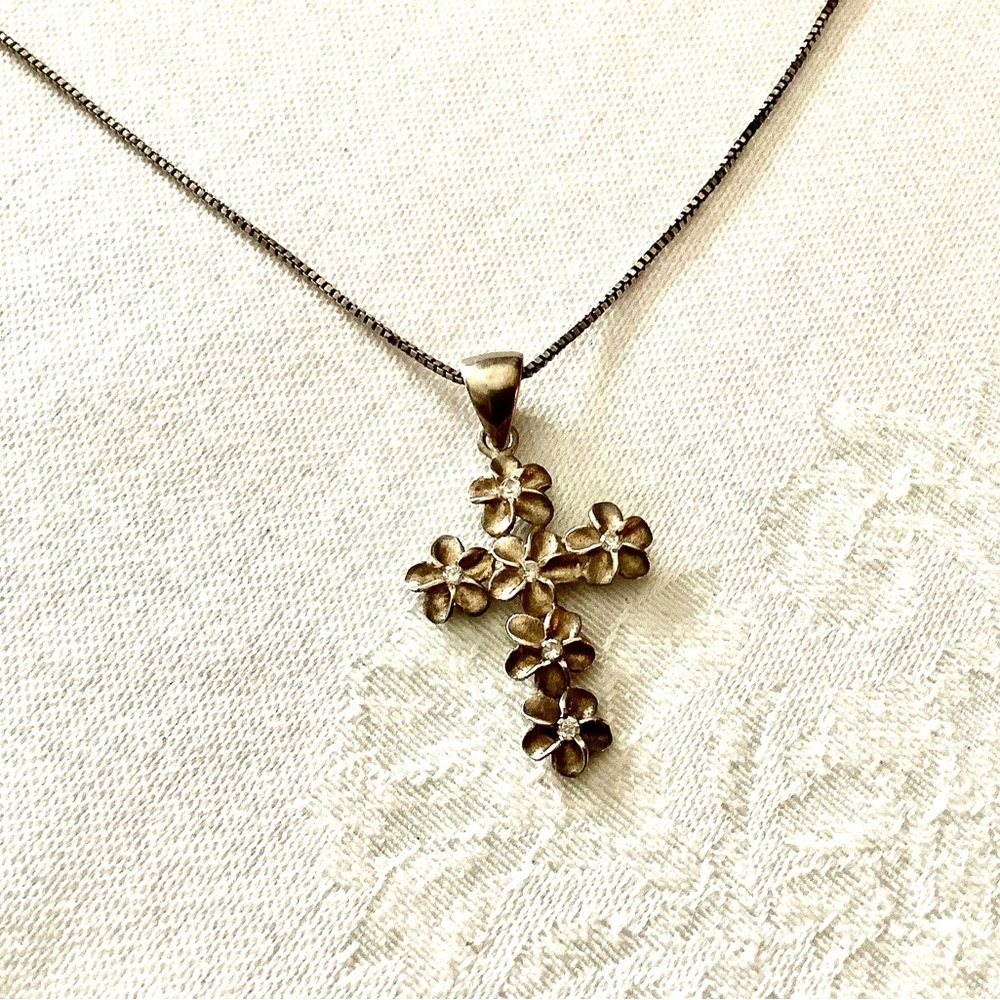 Sterling silver cross with flower detail. Marked​